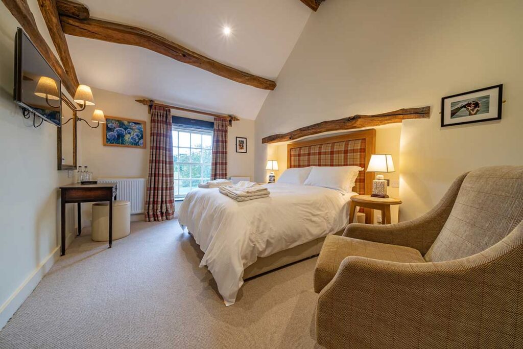 a beautifully appointed guest room at The Fleece Inn