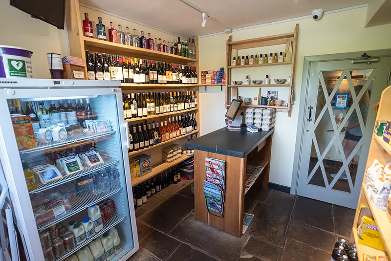 A wide angled vew of The Fleece Inn community shop, stocked with local produce and crafts.