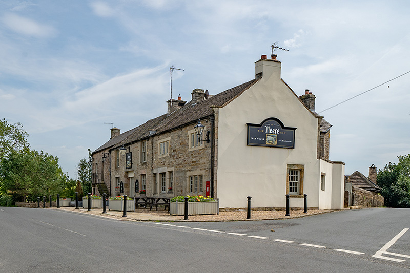 Exterior view of The Fleece Inn pub on the roadside in Dolphinholme, Lancashire